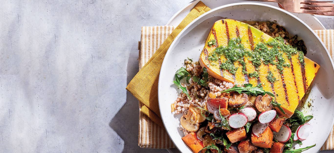 Butternut Squash Steak Supper in a white bowl against a white marble background