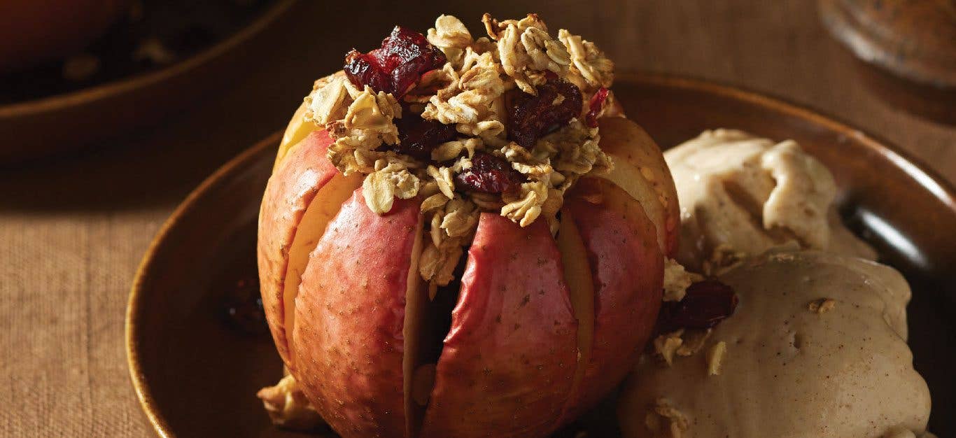 Blooming Apples with Cinnamon Nice Cream on a black plate and wood tabletop