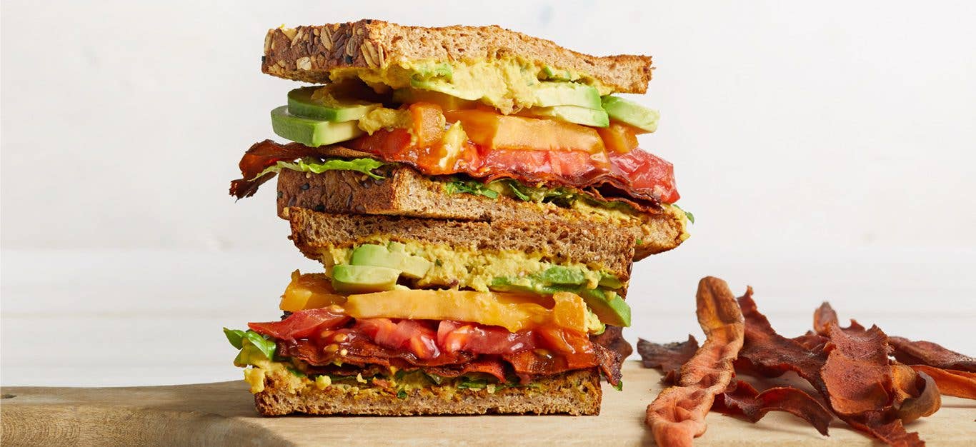 Vegan BLTA with Carrot Bacon on wooden cutting board