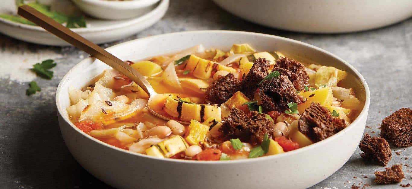 Delicata Squash and Roasted Cabbage Stew in a white bowl