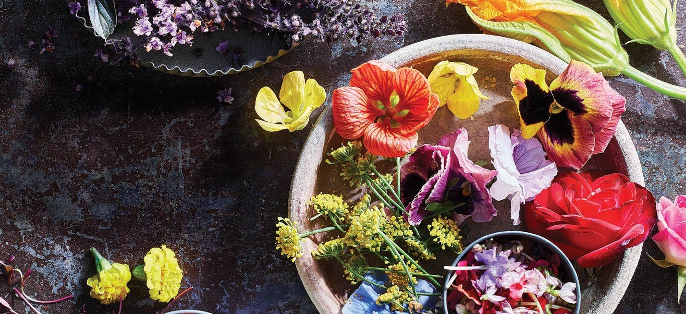 White ceramic bowl full of edible flowers