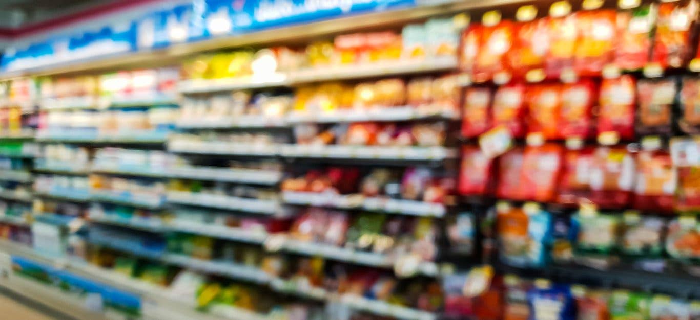 blurry photo of food in the refrigerated section of a grocery store