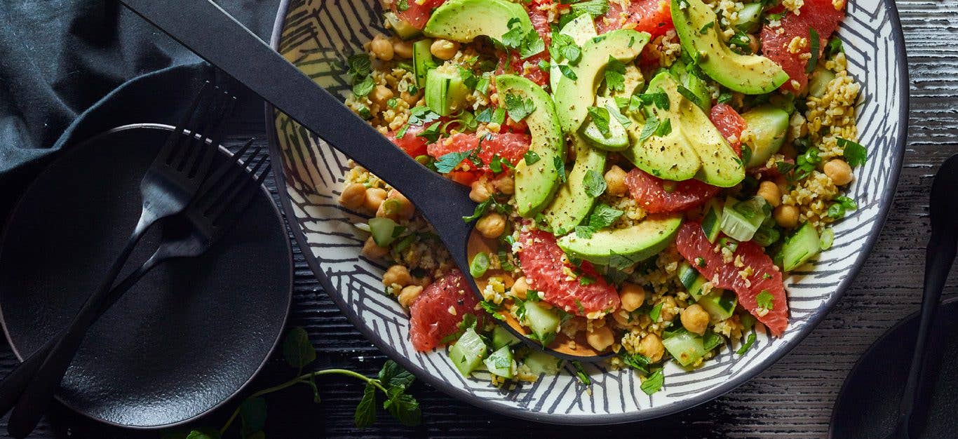 Freekeh grapefruit tabbouleh salad - avocado and grapefruit slices atop a colorful tabbouleh inspired salad