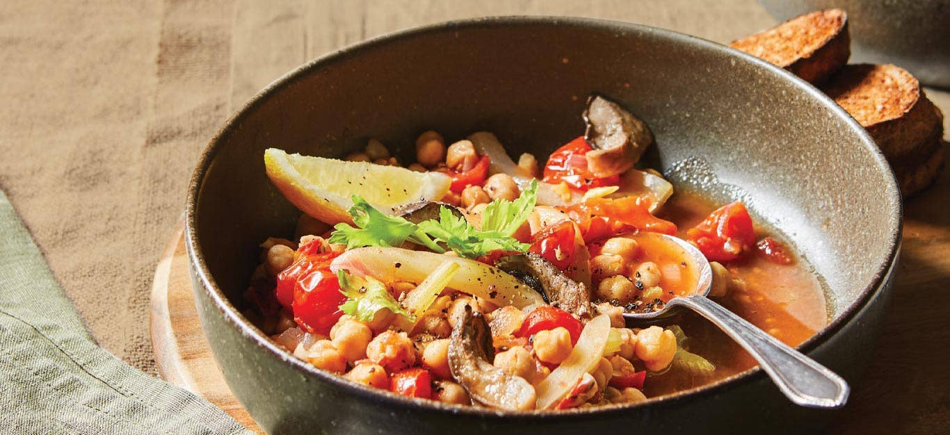 King Oyster Vegan Cioppino in a gray bowl with a metal spoon