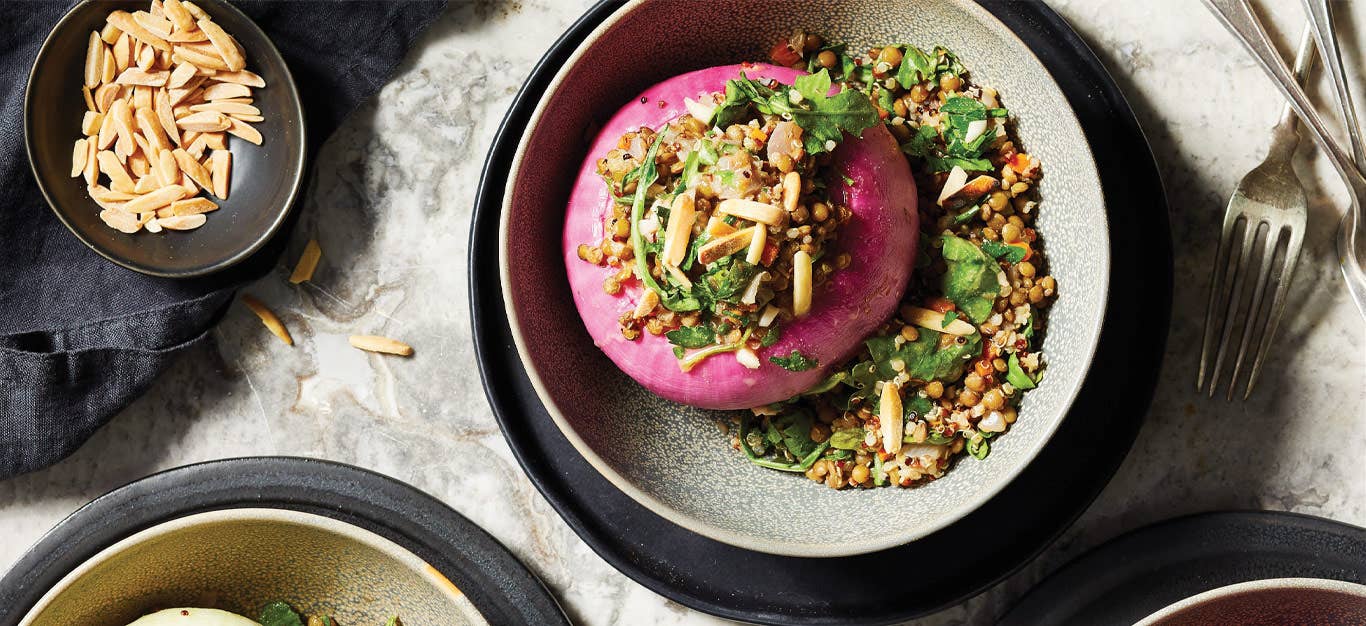 Provençal Stuffed Onions with Lentils, Quinoa, and Kale in white ceramic bowls