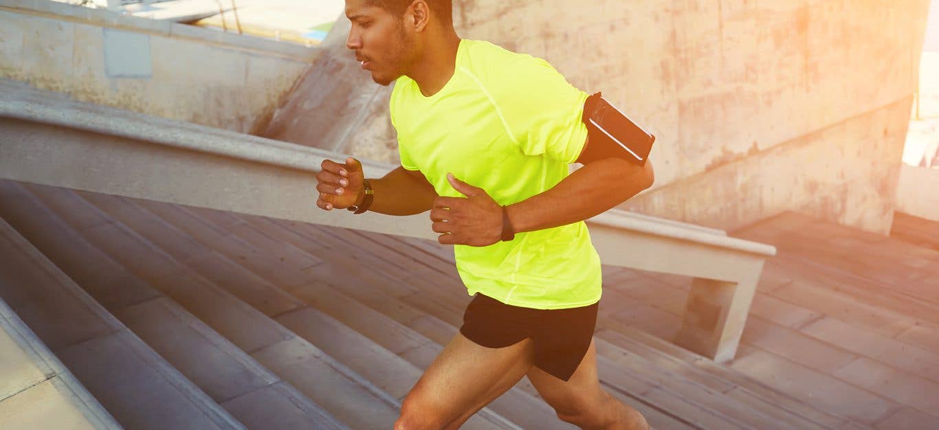 African-American man runs up a set of stairs outside