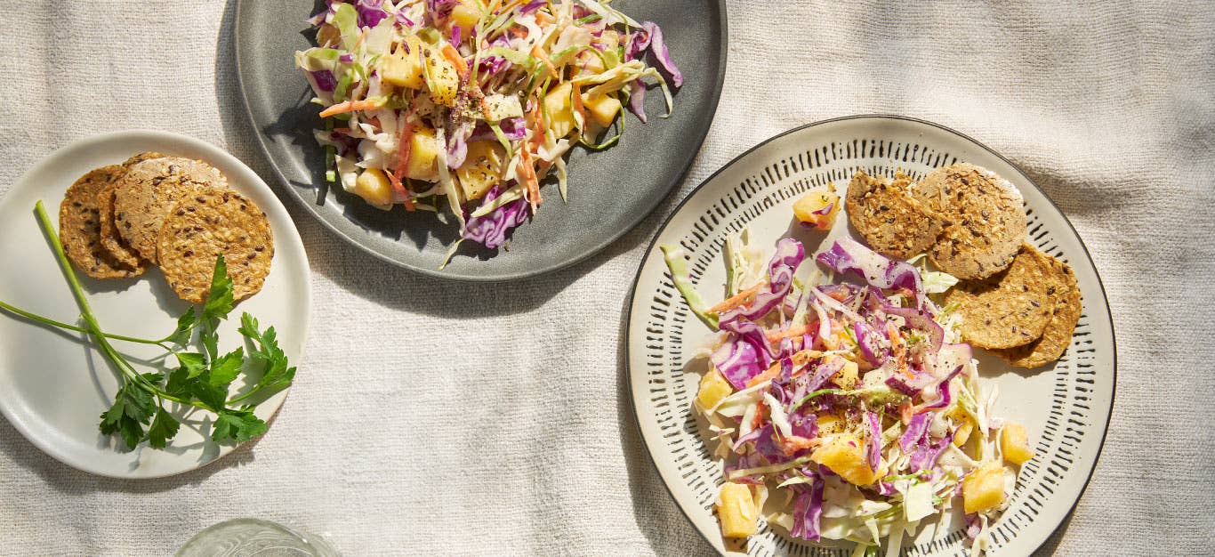 Vegan Pineapple Coleslaw on two ceramic plates with whole grain crackers