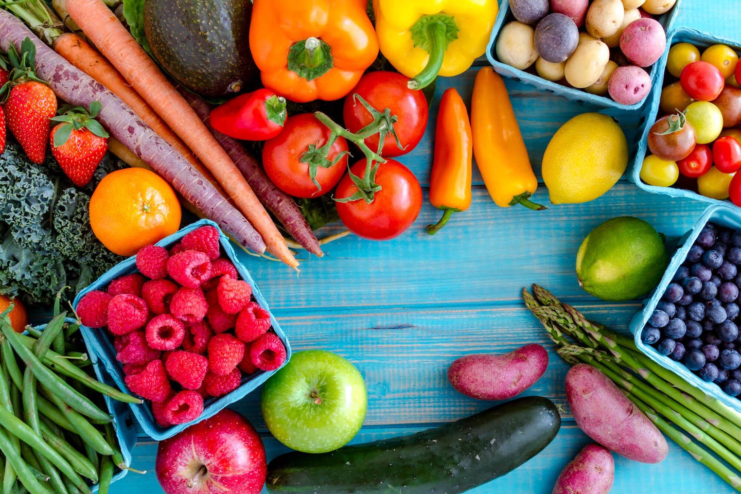 Fruits and vegetables on a blue table for the Forks Over Knives plant-based diet