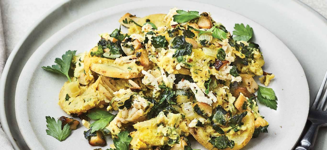 Potato-Spinach Casserole with Trumpet Mushrooms on a white plate