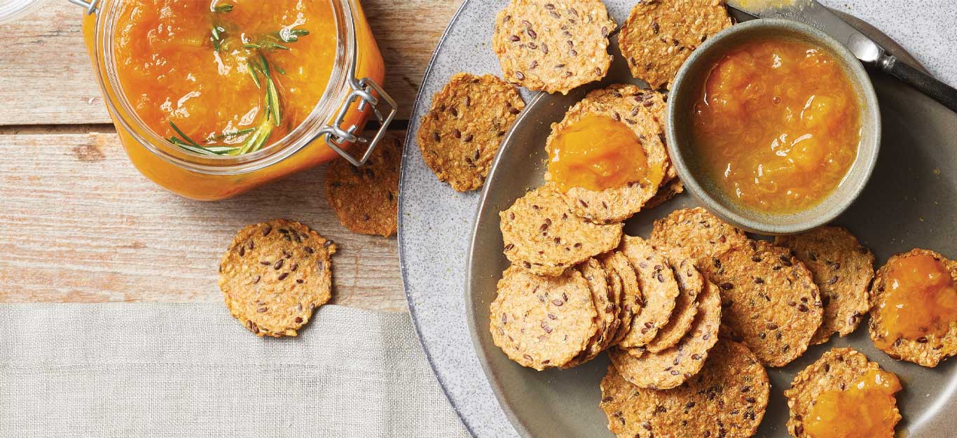 Rosemary-Apricot Preserves with seeded crackers on a gray plate