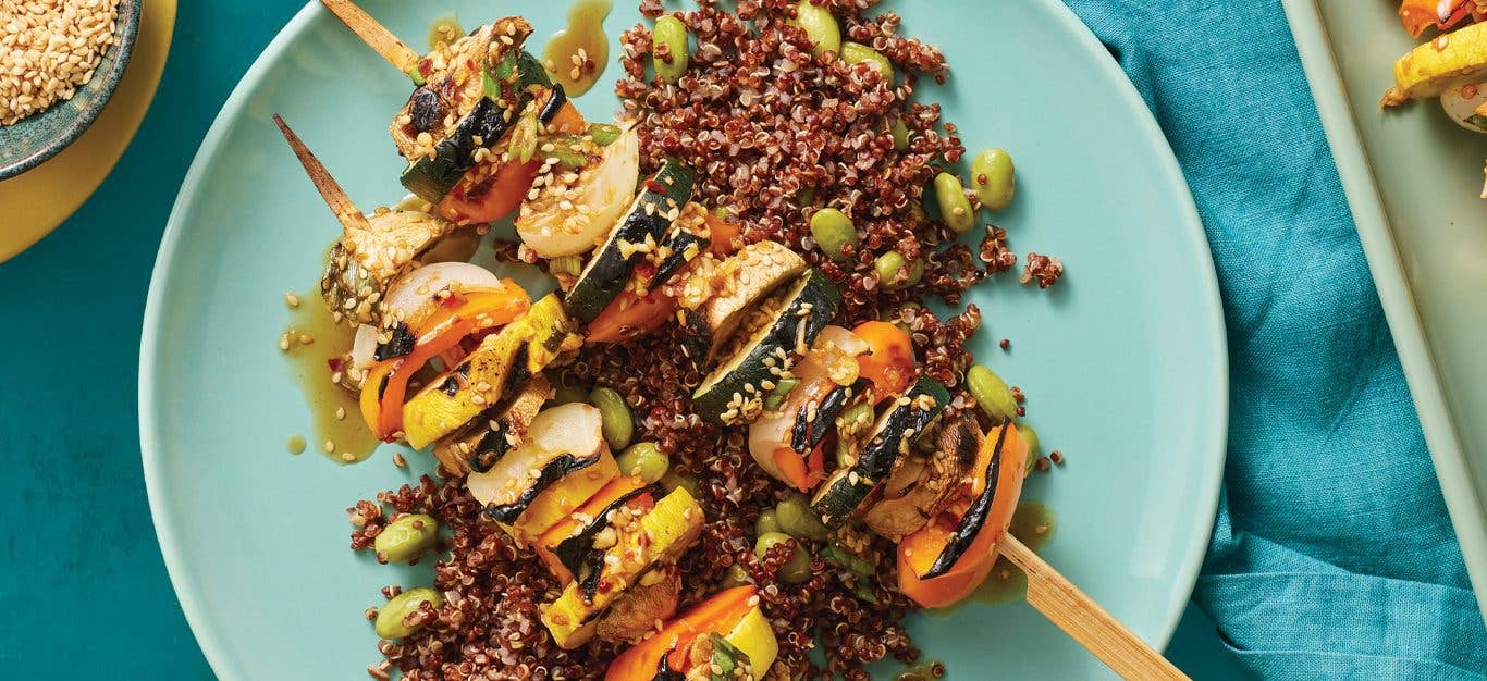 Summer Squash Veggie Skewers Over Edamame Quinoa on a blue plate