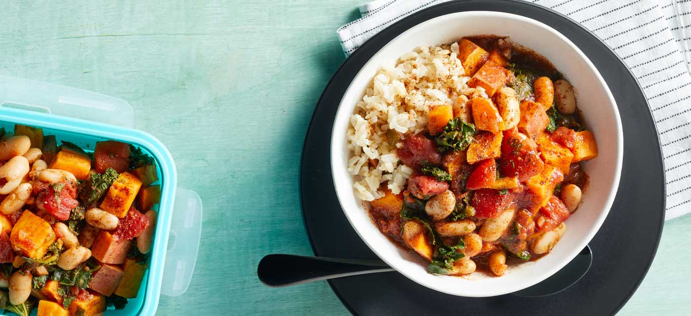 Microwave Sweet Potato and Kale Chili in a white bowl on a black plate