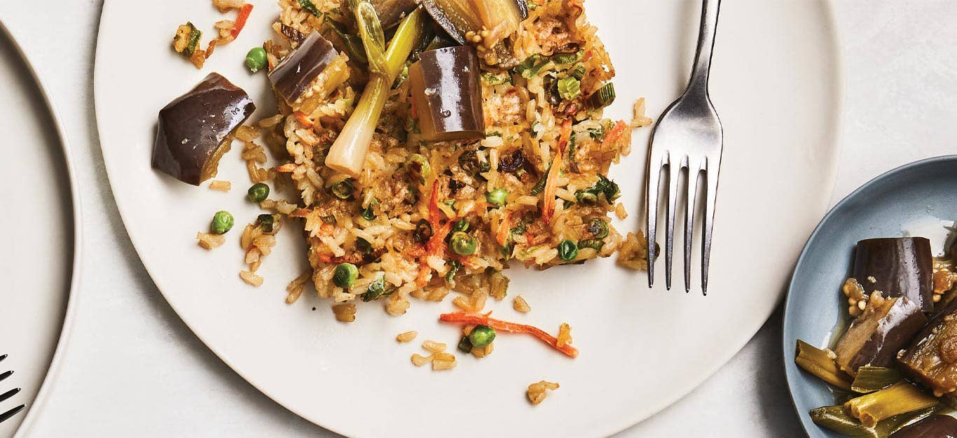 Fried Rice Waffles with Silken Braised Eggplant on a white plate with a metal fork