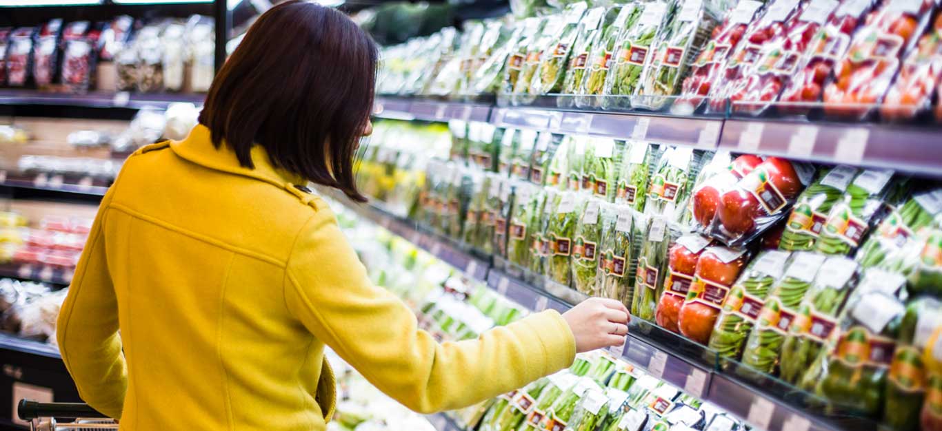 Young woman shopping in the supermarket produce section